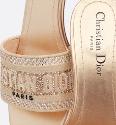 The Dway heeled slide has a hallmark and timeless style. The design is offered in an elegant variation of cotton embroidered with metallic thread and gold-tone strass. The embroidered upper, with its 'CHRISTIAN DIOR' signature makes it an immediate statement piece. Featuring a 4 cm (1.5) block heel, the slide lends a modern touch to any look.. 39.5 Dior Star, Icon Shoes, Ballerina Pumps, Christian Dior Fashion, Dior Book Tote, Christian Dior Couture, Dior Fashion, Silver Cufflinks, Boots And Sneakers