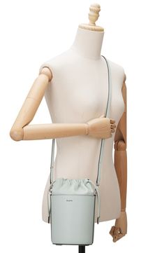 A scaled-down bucket bag with a modern silhouette is crafted of smooth leather offering optional wear with top carry handle or an adjustable, crossbody strap. 6"W x 9"H x 5"D 24" strap drop Drawstring closure Top carry handle; removable, adjustable crossbody strap Lined Leather Imported Modern Satchel Bucket Bag With Adjustable Handle, Spring Bucket Bag For On-the-go, Spring Bucket Bag, Spring Bucket Bag With Adjustable Strap For On-the-go, Modern Top Handle Bucket Bag For Spring, Spring Modern Top Handle Bucket Bag, Modern Bucket Shoulder Bag With Adjustable Handle, Spring Leather Bucket Bag With Adjustable Strap, Crossbody Bucket Bag With Dust Bag For Errands