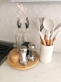 kitchen utensils are sitting on a cutting board