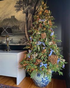 a decorated christmas tree in a blue and white vase