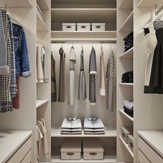 a walk in closet with lots of white drawers and clothes hanging on the shelves,