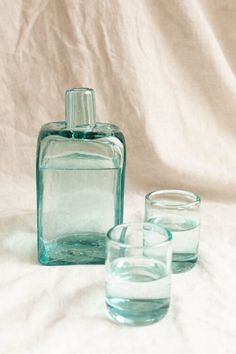 three glasses and a bottle on a white background