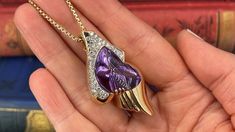 This unique freeform enhancer pendant is prong and bezel set with one (1) fantasy cut amethyst that weighs 23.23 carats. The top of the slide pendant is bead set with forty-four (44) round brilliant cut diamonds. The pendant measures 50.6mm long by 25.6mm wide and is 11.5mm deep. It hangs on a 18.5 inch long, 1.75mm fancy link chain that is finished with a lobster clasp. Pendant signed with jewelers hallmark. Luxury Amethyst Pendant Jewelry, Luxury Purple Teardrop Jewelry, Luxury Purple Drop Jewelry, Luxury Purple Jewelry For Collectors, Luxury Teardrop Amethyst Jewelry, Luxury Purple Pear-shaped Jewelry, Collectible Amethyst Pendant Jewelry, Elegant Heart Pendant Necklace For Collectors, Amethyst Pendant Necklace