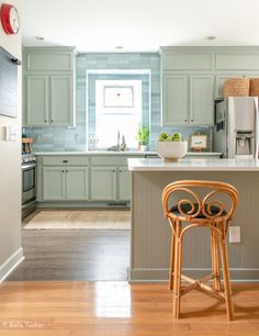 a kitchen with an island and stool in it