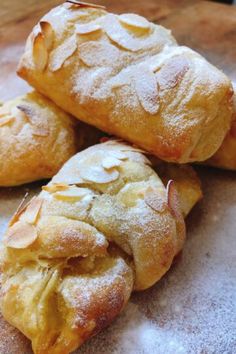 three pastries sitting on top of a wooden table