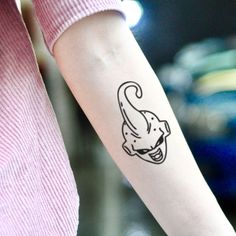 a woman's arm with a tattoo on it that has an elephant in the middle