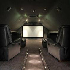 an empty home theater with two recliners