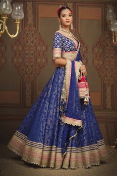 Electric blue cotton shimmer chanderi lehenga with attached cancan, abstract floral patterns, intricate gota, dori and badla work and rani pink broad border. Comes with padded, gota work blouse and lace border net dupatta. - Aza Fashions Blue Raw Silk Choli With Gota Work, Designer Meenakari Blue Lehenga, Blue Anarkali Choli With Meenakari, Designer Blue Pre-draped Saree With Gota Work, Blue Pre-draped Saree With Gota Work, Blue Raw Silk Pre-draped Saree For Reception, Blue Anarkali Set With Meenakari, Blue Pre-draped Saree With Gota Work For Navratri, Blue Meenakari Lehenga For Festive Occasions