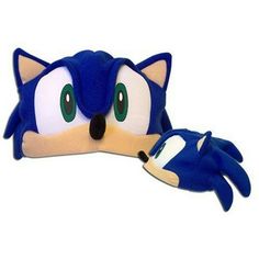 sonic the hedge plush toy laying on top of a white surface with green eyes and ears