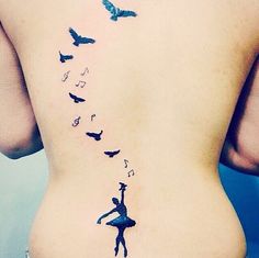 the back of a woman's stomach with birds flying over her and butterflies on it