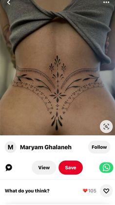 the back of a woman's stomach with an intricate tattoo design on her side