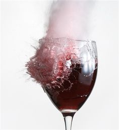 a wine glass filled with red liquid