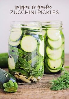 pickles and cucumbers in jars on a wooden table with text overlay