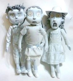 three dolls are standing next to each other