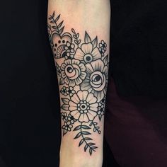 a black and white flower tattoo on the right arm with an eyeball in it