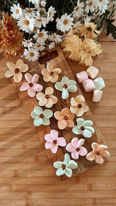 some flowers are sitting on a cutting board