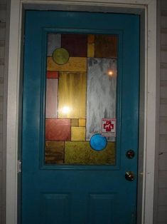 a blue front door with an abstract painting on it's glass paneled door