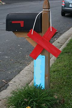 a mailbox with a red cross painted on it