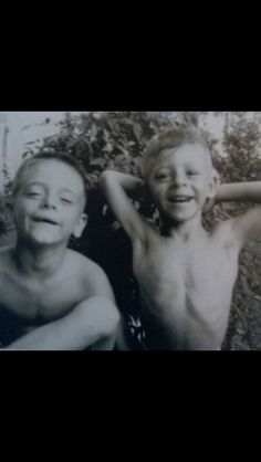 two young boys are posing for a photo