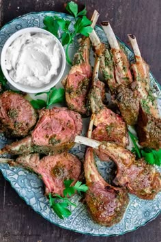 grilled lamb chops with tzatzh and sour cream on a blue plate