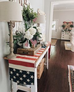 a living room filled with furniture and flowers on top of a flag table cloth covered bench