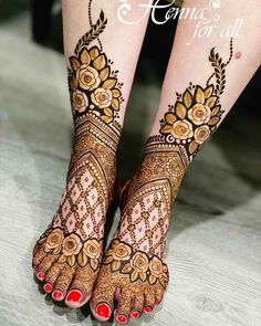 the feet and legs of a woman with henna tattoos