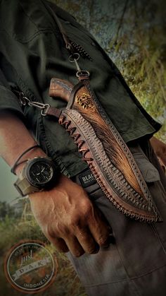 a man holding a knife in his hand and wearing a watch on the other side