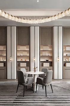 an elegant dining room with white walls and black and white striped rugs on the floor