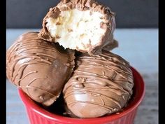 three chocolate covered desserts in a red bowl