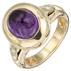 Amethyst and diamond ring. 1 oval cabochon amethyst set in 14k yellow gold with 2 round brilliant cut diamonds. Crown of ring opens up. 1 oval cut cabochon purple amethyst, VS 10.5mm x 8.5mm 2 round brilliant cut diamond, G SI2 approx. .10cts Size 7.5 and sizable 14k yellow gold Stamped: 14k 10.2 grams Width at top: 15.8mm Height at top: 9.5mm Width at bottom: 4.7mm Yellow Gold Cocktail Ring, Amethyst Set, Amethyst And Diamond Ring, Yellow Gold Diamond Ring, Gold Cocktail, Yellow Gold Setting, Gold Band Ring, 18k Yellow Gold Ring, Domed Ring