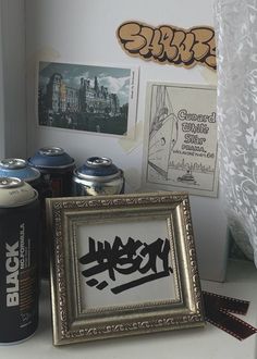 some cans and pictures on a table