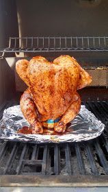 a cooked chicken sitting on top of a foil covered grill