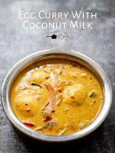 an egg curry with coconut milk in a metal bowl on a black countertop and text overlay reads egg curry with coconut milk