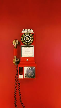 an old fashioned red phone on a red wall