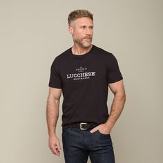 The Men's Lucchese Classic Embroidered Tee is a staple piece in our men's shirting collection. Under a vest or jacket, this embroidered tee is perfect for a day around the house or cheering on your team at the big game. Model is 6'1 and wearing size M. Classic Cotton Top With Embroidered Graphics, Handcrafted Boots, Handmade Boot, Embroidered Tee, Big Game, Staple Pieces, Mens Tees, Black Tee, The Man