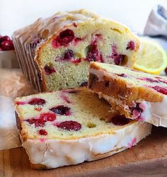 a loaf of lemon raspberry bread on a cutting board with slices cut out