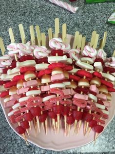 several skewers are arranged on a plate with toothpicks in the shape of letters