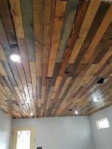 a room with wood planks on the ceiling