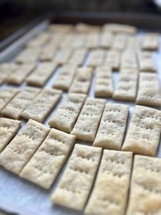 crackers are arranged on a baking sheet and ready to go into the oven