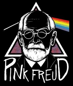 a man with glasses and a pink floyd t - shirt in front of a dark background