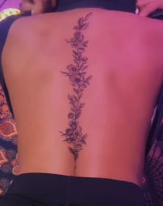 the back of a woman's body with flowers on it