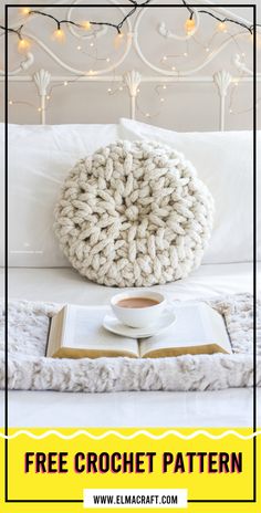 a crocheted pillow sitting on top of a bed next to an open book