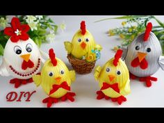 four paper mache chickens are standing next to each other with flowers in the background