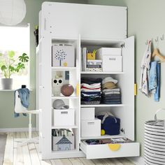 a white closet filled with lots of clothes