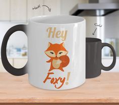 a coffee mug with an image of a fox on it and the words hey faxy