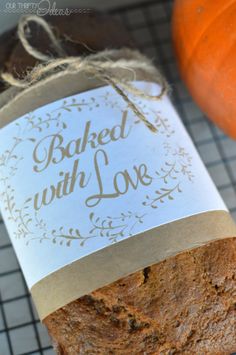 a loaf of bread sitting on top of a cooling rack next to an orange pumpkin