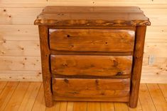 a wooden dresser sitting on top of a hard wood floor