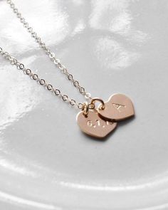 CUSTOMIZED HEART NECKLACE-A sweet, dainty heart necklace with the option for a single heart or several layered together.// MATERIAL //-Heart is 14 Karat Gold Filled and is approximately 10 mm. 14 Karat Gold Filled is usually a lifetime product, will not tarnish, and is perfect for those with sensitive skin.-Chain is 14 Karat Gold Filled, 16 inches (as seen in the photos with the blush sweater) or 18 inches. // CUSTOMIZATION //-Please include your customization in the box labeled "Add your person Dainty Heart Necklace, Customized Necklace, Caps Font, Blush Sweater, Your Person, Custom Necklace, Heart Necklace, Sterling Silver Necklaces, Hand Stamped