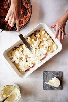 a person is cutting into some food on a table with other dishes and utensils