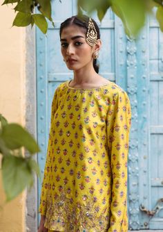 Editor's Note Bask in the brilliance of our sunshine yellow printed dupion silk kurta, elevated by hand-embroidered detailing. This ensemble exudes charm and sophistication. Paired harmoniously with printed kali pants, it's a perfect fusion of style and comfort, making it an exquisite choice for any occasion. Fabric: Dupion silk, net Color: Yellow Components: Kurta and sharara Occasion: Festive Disclaimer: Product color may slightly vary due to photographic lighting sources or your monitor setti